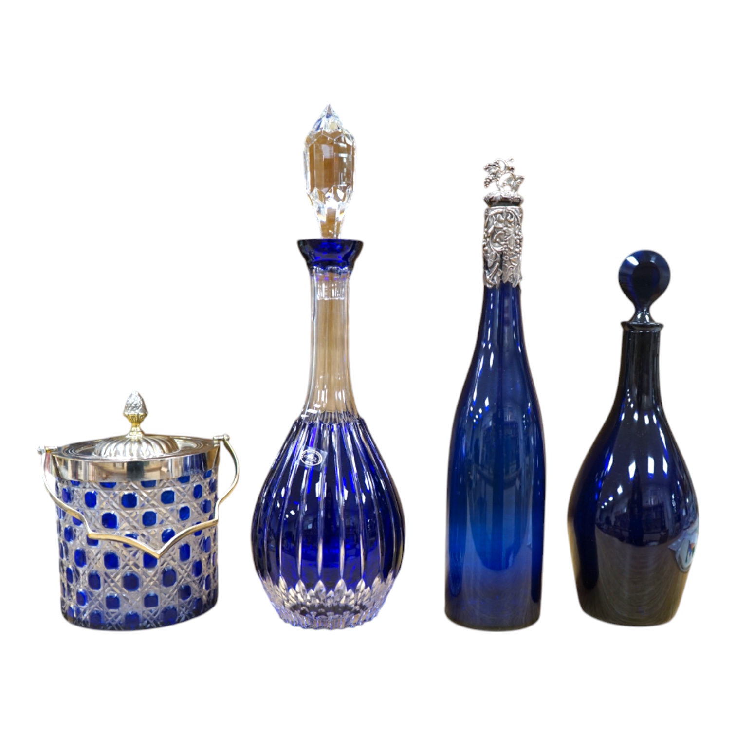 A collection of blue glassware comprising a late 18th century Bristol blue glass decanter and tear drop stopper, 30cm, a mid 19th century electroplate mounted blue glass decanter, a later Hungarian decanter and a similar